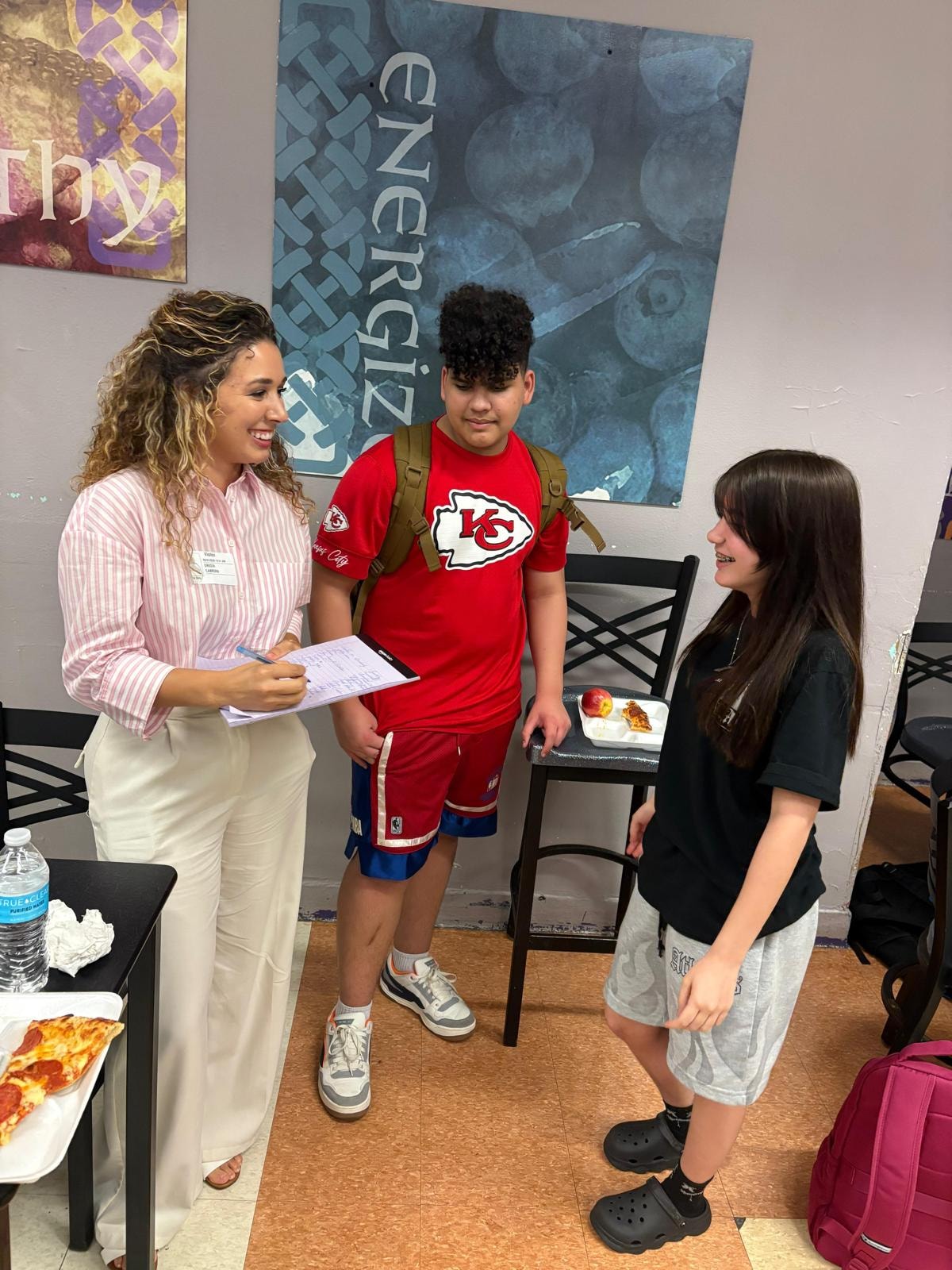 Gresia Cabrera with students at Northeast High School KCMO
